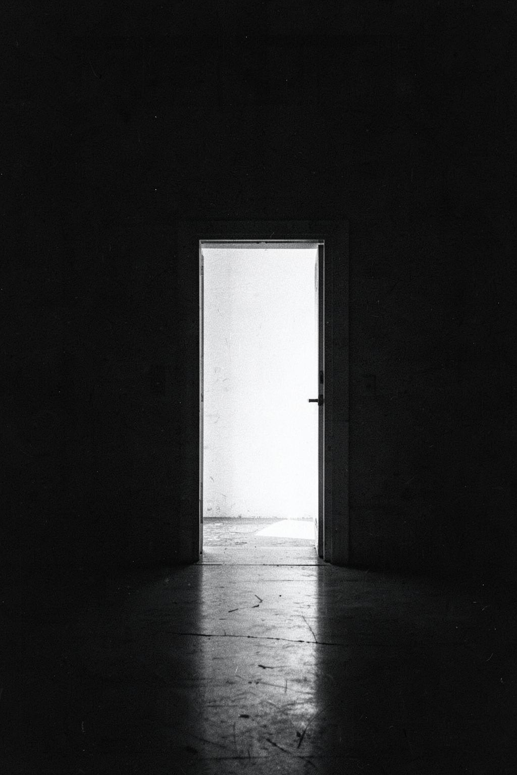 Open doorway of light in a dark studio